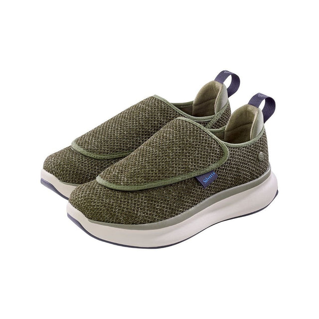 Pair of green slip-on shoes with white soles on a white background - okotoks hc pharmacy