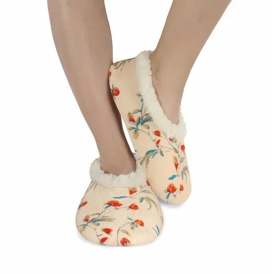 Floral patterned slippers with white fur trim worn by a person on a white background - okotoks hc pharmacy