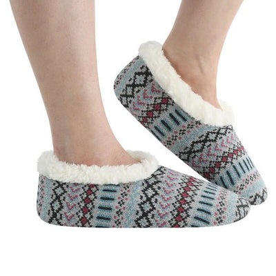 Patterned slipper socks with white fur lining worn by a person on a white background - okotoks hc pharmacy