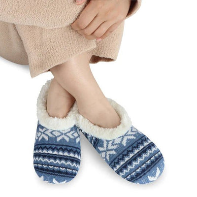 Blue and white patterned slippers with fluffy lining worn by a person on a white background - okotoks hc pharmacy
