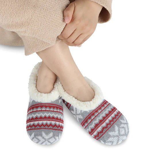 Person wearing cozy gray and red patterned socks with white trim on a white background - okotoks hc pharmacy