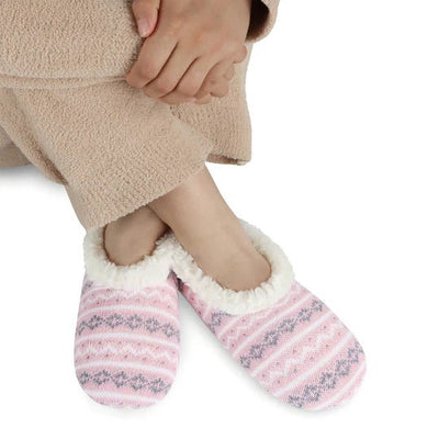Person wearing pink and gray striped slippers with a white background - okotoks hc pharmacy