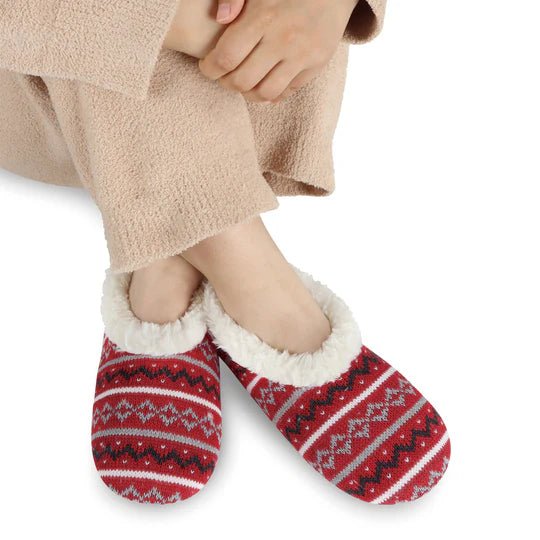 Red and white patterned slippers worn with beige pants on a white background - okotoks hc pharmacy