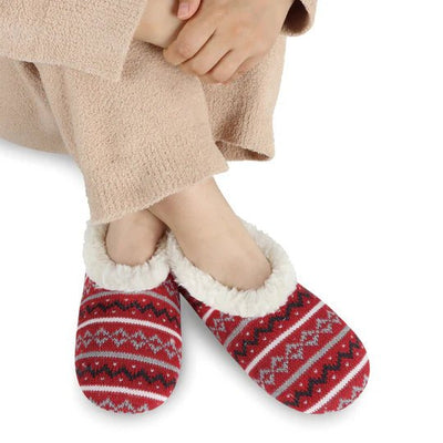 Red and white patterned slippers worn with beige pants on a white background - okotoks hc pharmacy