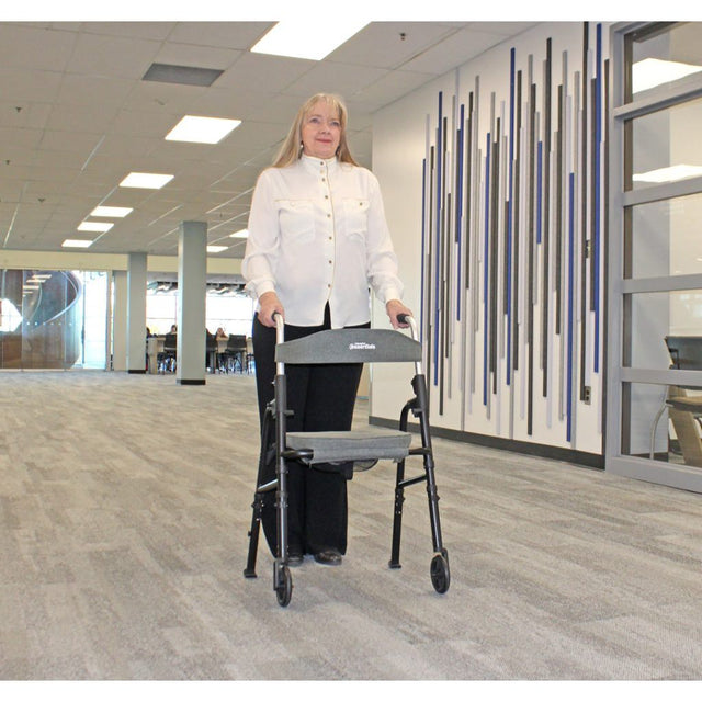 Person using a walker in an indoor setting with a modern design. - okotoks hc pharmacy