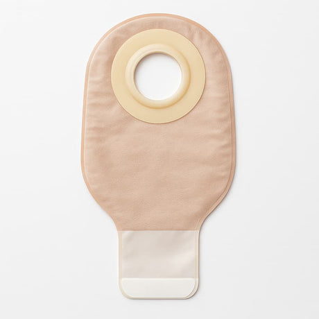 Flat lay of a beige ostomy one-piece pouch with integrated flange and barrier ring on a white background