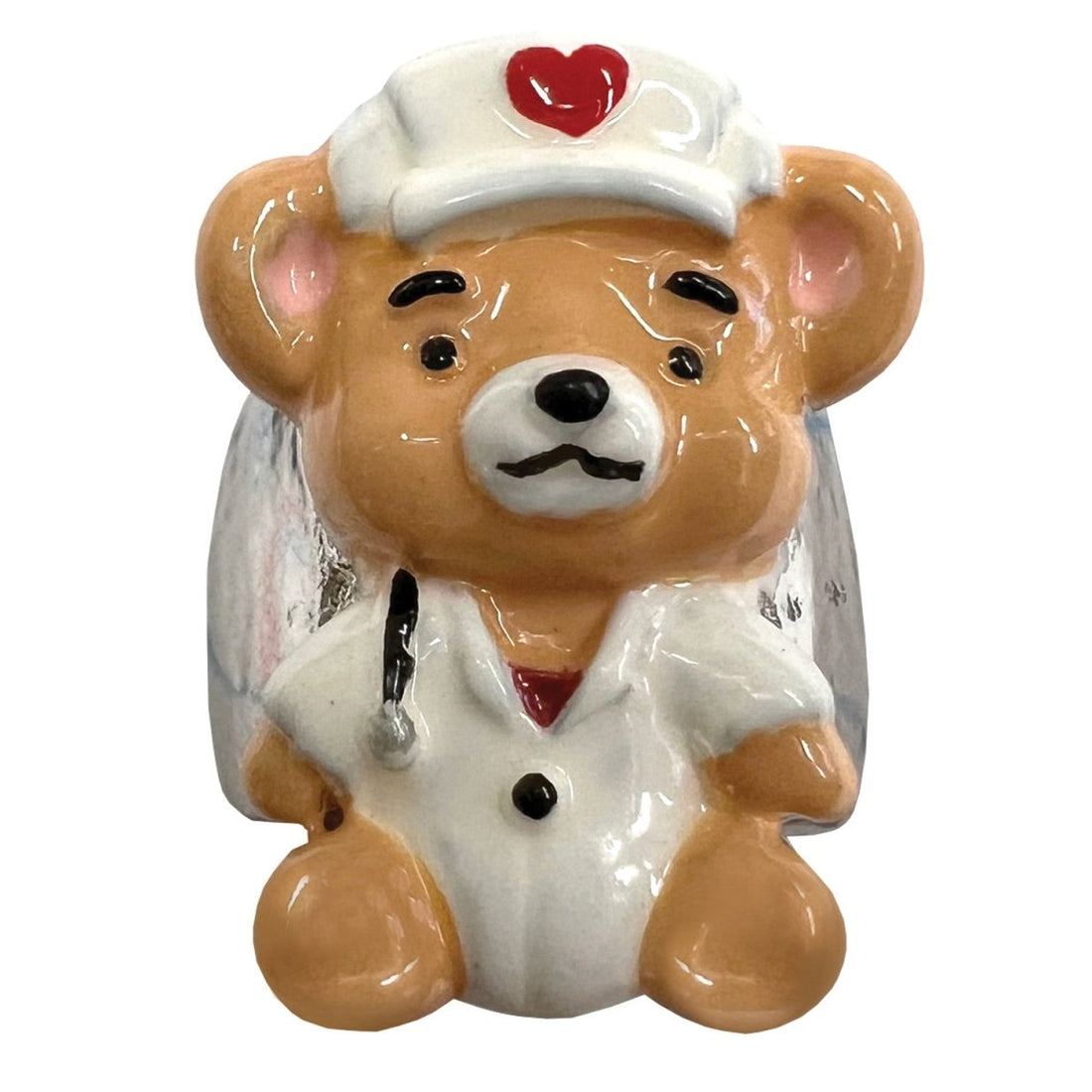 Teddy bear figurine dressed as a doctor with a stethoscope on a white background - okotoks hc pharmacy