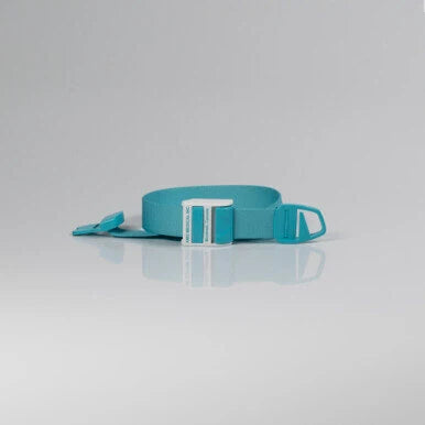 A turquoise blue web belt with a white plastic buckle, shown coiled on a light gray reflective studio surface. - okotoks hc pharmacy