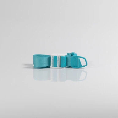 A turquoise blue adjustable strap with a white plastic buckle, displayed on a clean white reflective surface. - okotoks hc pharmacy