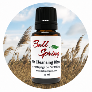 A 15 ml bottle of Bell Spring Air Cleansing Blend essential oil on a circular background depicting a field of reeds under a blue sky. - okotoks hc pharmacy
