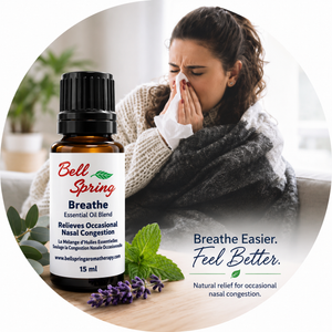 Bell Spring Breathe essential oil bottle shown next to a woman snezing on a couch, with text reading 'Breathe Easier. Feel Better. - okotoks hc pharmacy