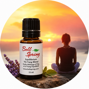 A 15 ml bottle of Bell Spring Equilibrium Yin Yang Blend essential oil placed in front of a circular background graphic showing a woman meditating at sunset with lavender sprigs and mint leaves. - okotoks hc pharmacy