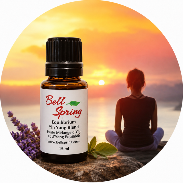 A 15 ml bottle of Bell Spring Equilibrium Yin Yang Blend essential oil placed in front of a circular background graphic showing a woman meditating at sunset with lavender sprigs and mint leaves. - okotoks hc pharmacy