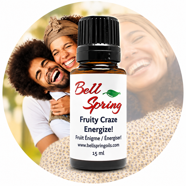 A 15 ml bottle of Bell Spring 'Fruity Craze Energize!' essential oil centered over a circular background photo of a smiling couple, with the product label clearly visible. - okotoks hc pharmacy
