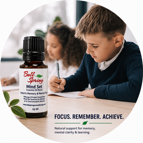 A 10 mL bottle of Bell Spring Mind Set essential oil blend is shown in the foreground, with a boy studying at a desk in a softly blurred classroom background. The image is framed in a circular graphic with the text 'FOCUS. - okotoks hc pharmacy