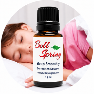 A 15 ml amber glass bottle of Bell Spring Sleep Smoothly essential oil with a black cap and white label, shown in front of a circular background depicting a sleeping child. - okotoks hc pharmacy