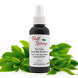 Bell Spring Tea Tree Essential Oil Spray in a 120 ml dark amber bottle with a white spray cap, styled with fresh green tea tree leaves on a white background. - okotoks hc pharmacy