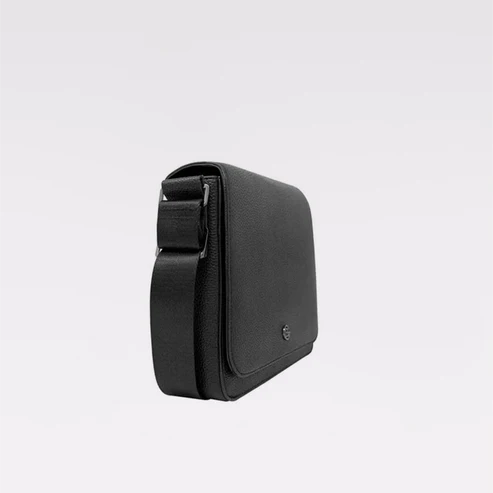 A black textured leather crossbody phone bag with a matching adjustable shoulder strap, shown from a side profile view against a clean white background. - okotoks hc pharmacy