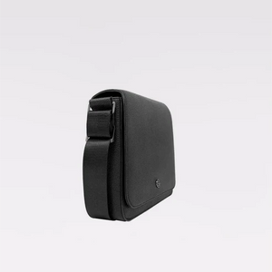 A black textured leather crossbody phone bag with a matching adjustable shoulder strap, shown from a side profile view against a clean white background. - okotoks hc pharmacy