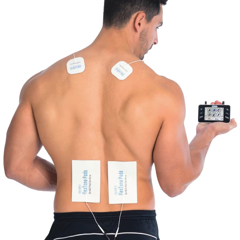 A shirtless man shown from the back on a white background, wearing four square adhesive TENS unit electrode pads on his upper back and lower back while holding a small black electronic controller in his hand. - okotoks hc pharmacy