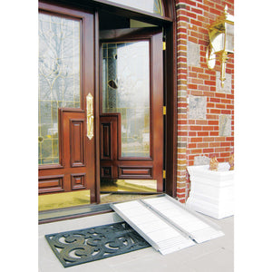 Wooden front door with glass panels and a white wheelchair ramp leading up to it, on a brick wall background. - okotoks hc pharmacy
