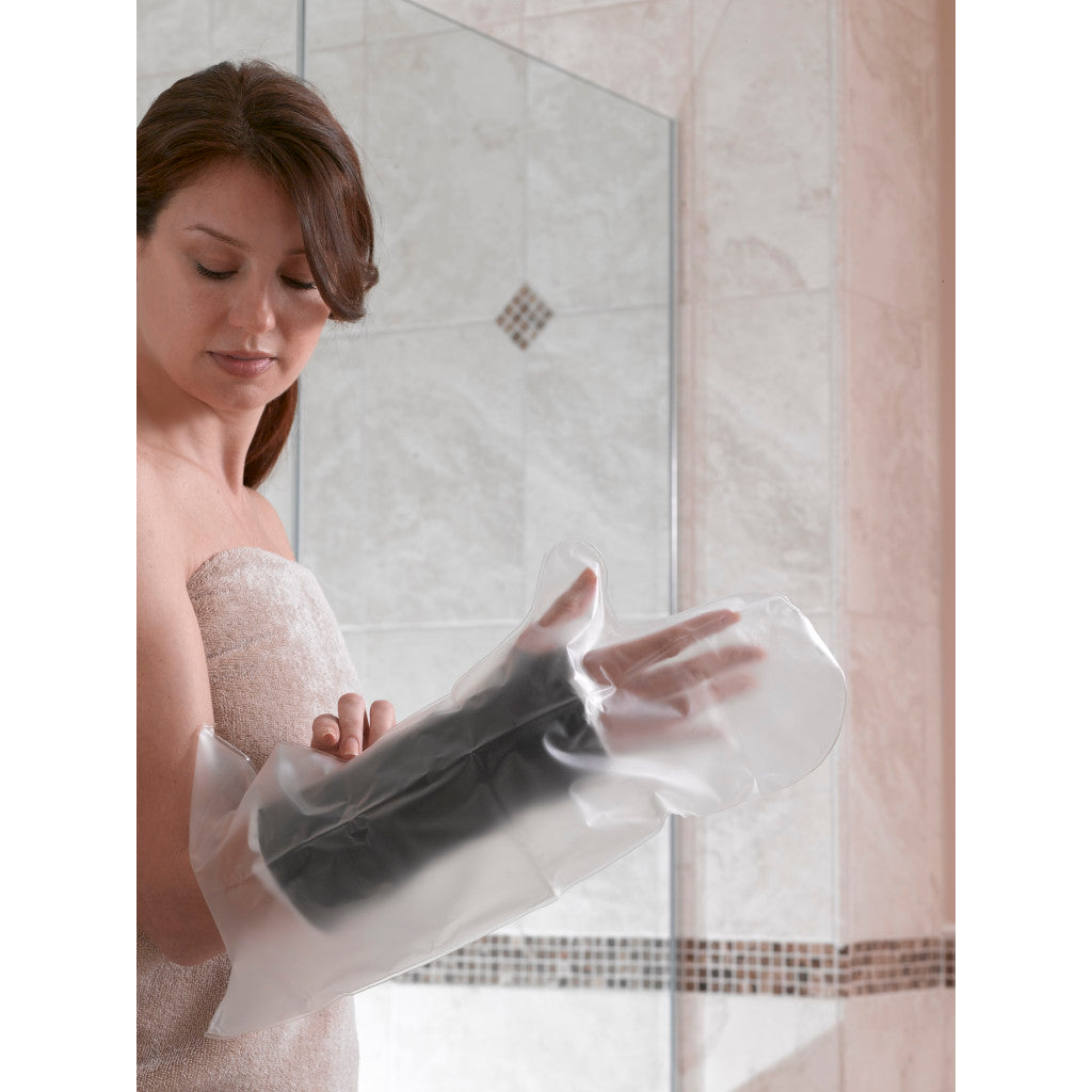 Woman applying a black foot mask in front of a mirror. - okotoks hc pharmacy
