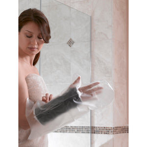 Woman applying a black foot mask in front of a mirror. - okotoks hc pharmacy