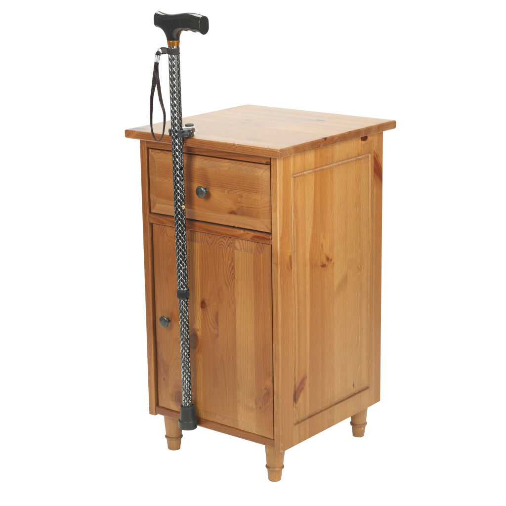 Wooden cabinet with a walking cane on a white background - okotoks hc pharmacy