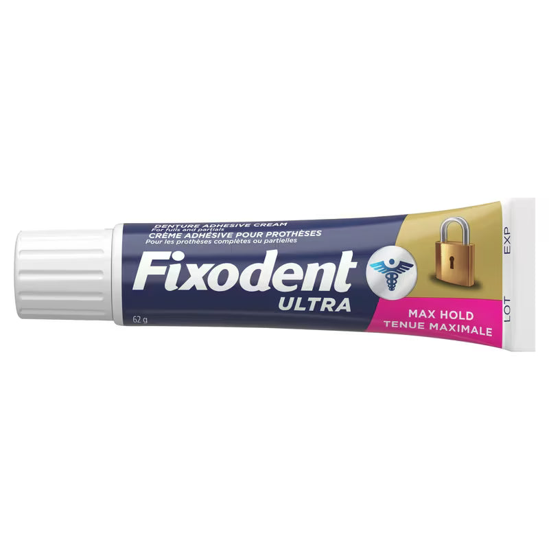 A tube of Fixodent Ultra adhesive cream for dental prostheses, featuring a navy blue and gold label with a pink accent band, shown against a plain white background. - okotoks hc pharmacy