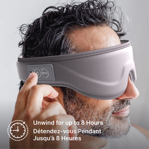 A man wearing a gray electronic eye mask with a control panel on the headband, shown in a close-up profile. French text at the bottom reads 'Unwind for up to 8 Hours'. - okotoks hc pharmacy