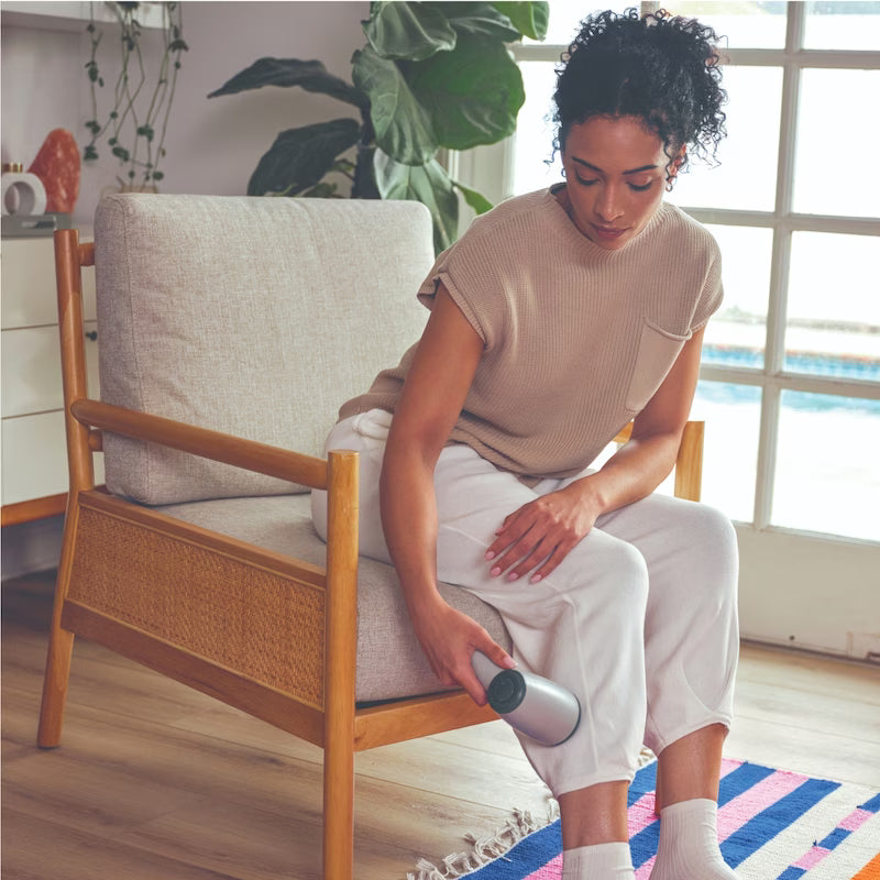 Woman cleaning a chair with a massager in a home setting - okotoks hc pharmacy
