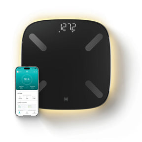 Smart scale with digital display and smartphone app on a white background. - okotoks hc pharmacy