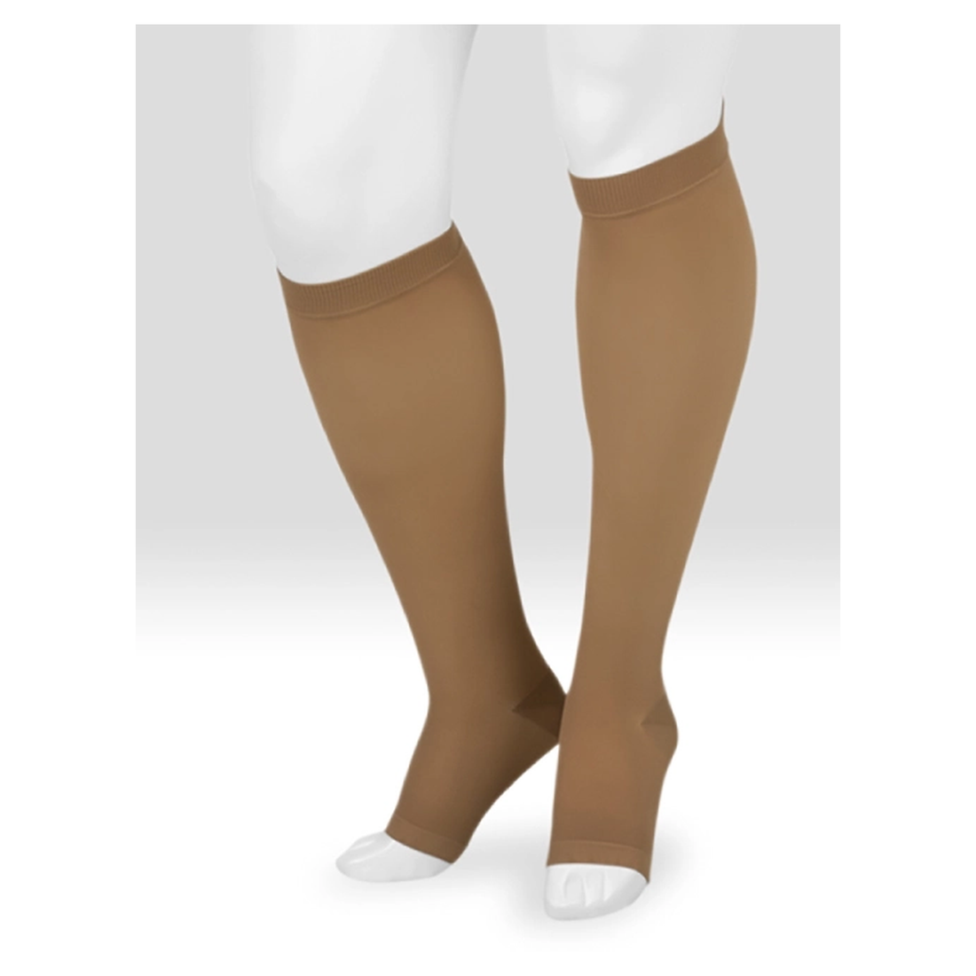 A pair of knee-high compression socks in a warm tan color, shown on a white mannequin leg form against a light gray studio background. - okooks hc pharmacy