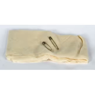 Two gold-colored pins on a beige fabric background - okotoks hc pharmacy