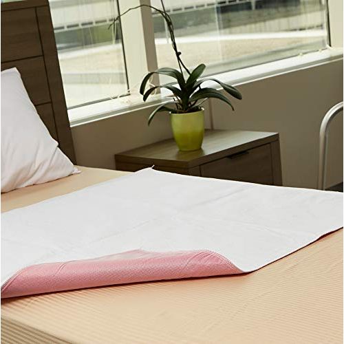 White underpad with pink border on a bed next to a window with a plant on a nightstand. - okotoks hc pharmacy