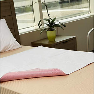 White underpad with pink border on a bed next to a window with a plant on a nightstand. - okotoks hc pharmacy