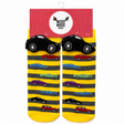 A pair of children's novelty socks in yellow and gray stripes with cartoon cars, shown hanging from a red 'Messy Moose Socks' retail hanger. The socks feature black car-shaped heels and toes with white wheels, and smaller multicolored cars printed along the sides. - okotoks hc pharmacy