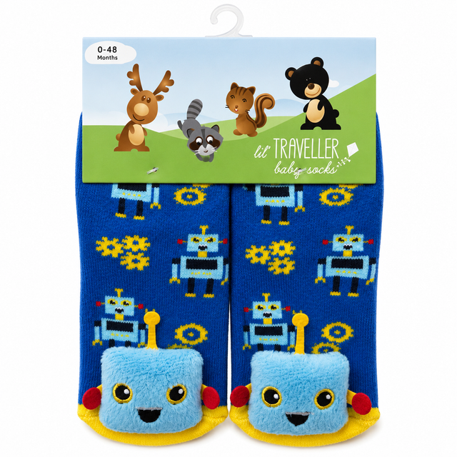 A pair of baby socks in blue with a robot pattern, packaged on a hanger card. The socks feature a plush light blue robot face on the toes, yellow wheels, and small red accents. - okotoks hc pharmacy