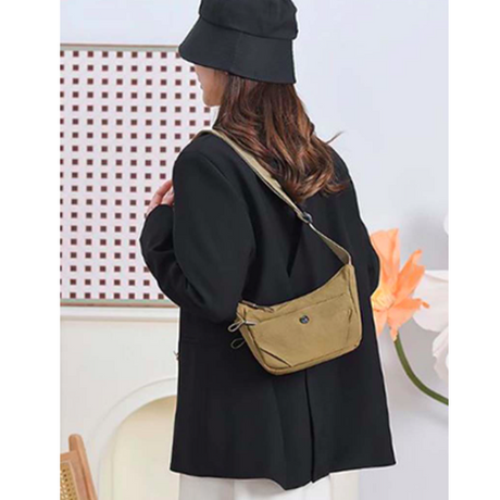 Person wearing a black coat and hat with a beige bag on a white background - okotoks hc pharmacy