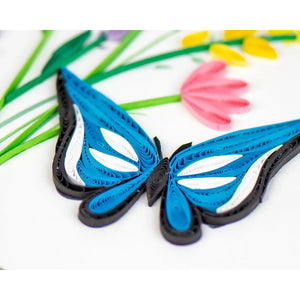 Quilled butterfly with colorful flowers in the background - okotoks hc pharmacy
