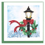 Decorative card with a Christmas-themed street lamp, red ribbon, and greenery against a snowy background. - okotoks hc pharmacy