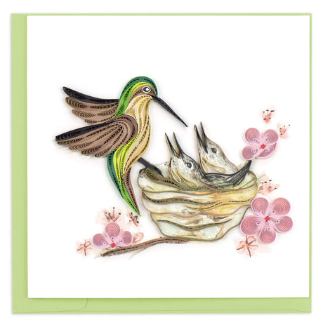Quilled artwork of a hummingbird and eggs with pink flowers on a white background - okotoks hc pharmacy