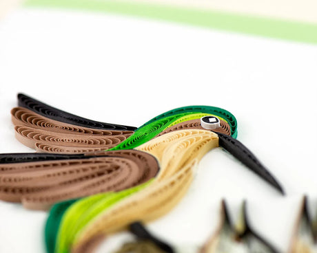 Colorful paper quilled bird on a white background - okotoks hc pharmacy