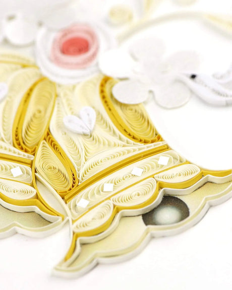 Quilled paper art of a bells with intricate patterns on a white background - okotoks hc pharmacy