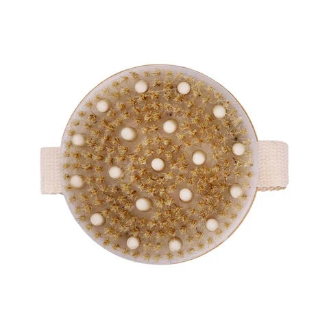 A circular foot massage brush with a beige fabric strap and a textured surface covered in small white massage nodes and gold-toned bristles, shown on a plain white background. - okotoks hc pharmacy