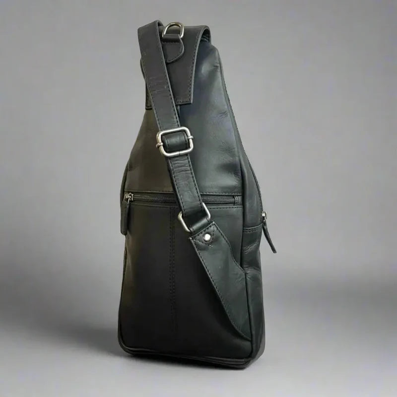 Black leather sling bag on a gray background - okotoks hc pharmacy