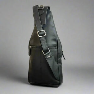 Black leather sling bag on a gray background - okotoks hc pharmacy