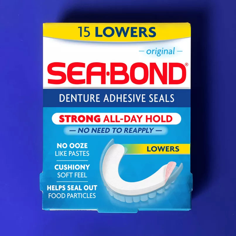 A box of Sea-Bond Denture Adhesive Seals, 15 lowers, shown against a solid blue background. The packaging is white, blue, and yellow, featuring the red Sea-Bond brand logo and an illustration of a white dental low. - okotoks hc pharmacy