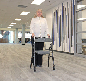 Person using a walker in an indoor setting with a modern design. - okotoks hc pharmacy