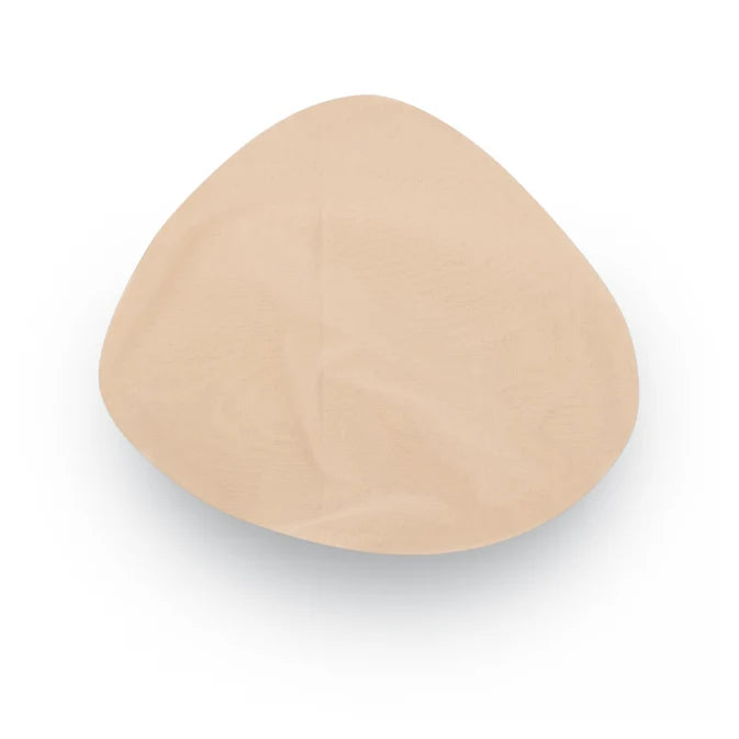 A single beige silicone or latex breast implant cup shown from a top-down view on a white background. - okotoks hc pharmacy